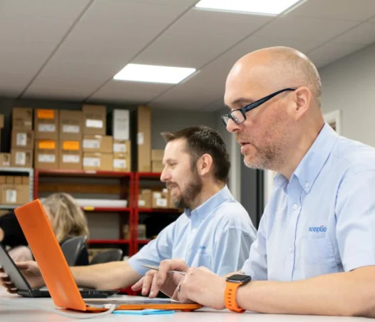 two men using laptop